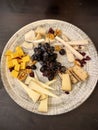 Cheese board with assorted cheeses, grapes, and nuts Royalty Free Stock Photo