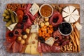 Cheese board with assorted cheese, nuts, grape, smoked meat, smoked sausages and crackers. Charcuterie and cheese platter Royalty Free Stock Photo