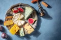 Cheese board with Brie, blue cheese and other types, with a wine corkscrew Royalty Free Stock Photo