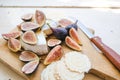 Cheese board with figs on white