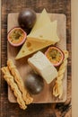 Cheese board with fruits.assorted cheese on a wooden board with herbs and fruits.Cheese cut with fruits. Royalty Free Stock Photo