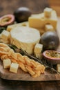 Cheese board set. assorted cheese on a wooden board with herbs and fruits.Cheese cut with fruits.Hard and soft cheeses Royalty Free Stock Photo