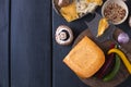 Cheese on the board and spices. Black background Royalty Free Stock Photo
