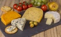 Cheese board with three cheeses, gouda with pimento, gouda with