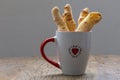 Cheese bread in the form of chopsticks in a mug Royalty Free Stock Photo