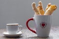 Cheese bread in the form of chopsticks in a mug Royalty Free Stock Photo