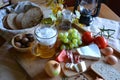 Cheese, bread, onions, wine, tomatoes and beer Royalty Free Stock Photo