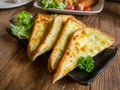 cheese bread in a rectangle black dish