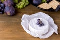 Cheese Brie Camembert with Figs and Grapes on wooden table Food for Wine Figs Green and Red Grapes Crackers Knife Plate Snacks Cop Royalty Free Stock Photo