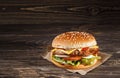 Cheese burger with grilled meat, cheese, tomato, on craft paper Royalty Free Stock Photo