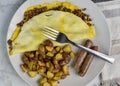 cheese burger omelet with hpme fries and sausage Royalty Free Stock Photo
