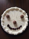 Smiling Cheese cake face, with eyes of Chocolates