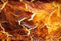 Cheese cake crust, burned and cracked, golden brown abstract texture, close up