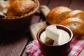 Cheese camembert or brie with bagette in ceramic pot ready to eat served on wooden board