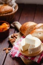 Cheese camembert or brie with bagette, nuts and dried apricots served on wooden board