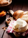 Cheese camembert or brie with bagette, nuts and dried apricots served on wooden board
