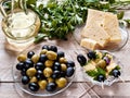 Cheese, canapÃÂ©s of cheese and olives with greens, olives and olives, parsley on a wooden background Royalty Free Stock Photo