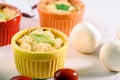 Cheese casserole with mushrooms in colorful cocoanuts on white background