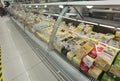 Cheese cheeses on super market front store prices labes on it , glass protective front