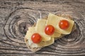 Cheese Sandwich With Three Cherry Tomatoes In Porcelain Plate Set On Old Knotted Rough Pine Wood Table