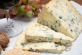 Red porto and cheese pairing, blue matured stilton English cheese served as dessert with walnuts and glass ruby porto wine