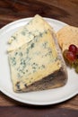 Red porto and cheese pairing, blue matured stilton English cheese served as dessert with walnuts and glass ruby porto wine