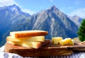 Cheese collection, French comte, beaufort or abondance cow milk cheese served outdoor with Alps mountains peaks on background Royalty Free Stock Photo