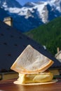 Cheese collection, piece of French Alps mountains blue cheese BLEU DE SAVOIE served with white wine outdoor in French Alps