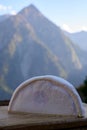 Cheese collection, French reblochon de savoie cheese served outdoor in Savoy region, with Alpine mountains peaks on background