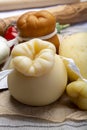 Italian provolone or provola caciocavallo hard and smoked cheeses in teardrop form served on old paper close up