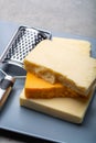 Cheese collection, matured and orange original British cheddar cheese in blocks served on grey plate