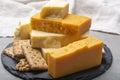 Cheese collection, matured and orange original British cheddar cheese in blocks served with crackers