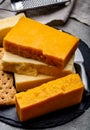 Cheese collection, matured and orange original British cheddar cheese in blocks served with crackers