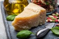 Cheese collection, piece of hard aged Italian parmesan or grana padano cheese with olive oil and tricolore italian pasta