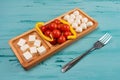 Cheese compartmental dish with different cheeses, on rustic wooden background