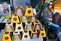 Cheese conical head stacked in a pyramid and packed into white and yellow cartons. To the left of the frame in the background Phot