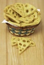 Cheese cookie on a wood table with a full basket Royalty Free Stock Photo