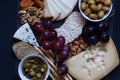 Cheese,cracker,grape,nuts on a black background Royalty Free Stock Photo