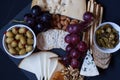 Cheese,cracker,grape,nuts on a black background Royalty Free Stock Photo