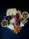 Cheese,cracker,grape,nuts on a black background Royalty Free Stock Photo