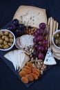 Cheese,cracker,grape,nuts on a black background Royalty Free Stock Photo
