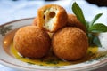 Cheese croquettes with olive oil and herbs, closeup