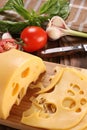 Cheese on a cutting board, basil, tomato