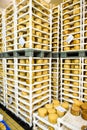 Cheese factory warehouse with shelves stacked with cheese Royalty Free Stock Photo