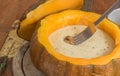 Cheese fondue in a roasted pumpkin with chestnut mushroom on a f Royalty Free Stock Photo