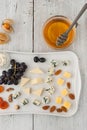 Cheese and fruit mix on the white ceramic plate Royalty Free Stock Photo