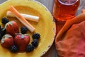 Cheese,fruit, on a vibrant plate with a glass of juice Royalty Free Stock Photo