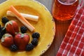 Cheese,fruit, on a vibrant plate with a glass of juice Royalty Free Stock Photo