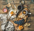 Cheese, fruit and wine set over rustic wooden background