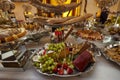 Cheese, fruits, green grapes, nuts, cherries, bread, luxury candy bar